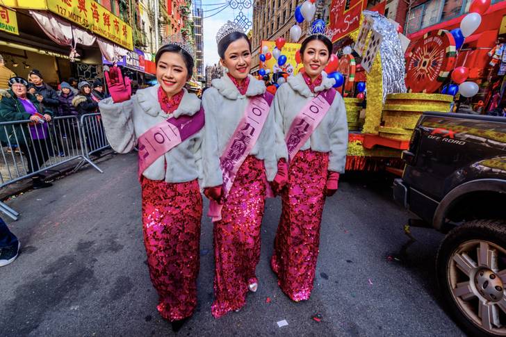 three women in pink glittery outfits celebrate Lunar New Year in Chinatown